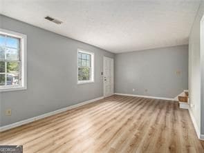 spare room featuring light hardwood / wood-style flooring