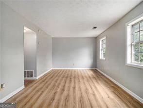 spare room featuring light hardwood / wood-style flooring