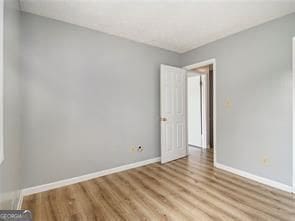 unfurnished room with light hardwood / wood-style floors