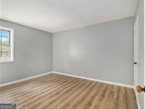 spare room with light hardwood / wood-style floors