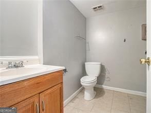 bathroom with tile patterned floors, vanity, and toilet