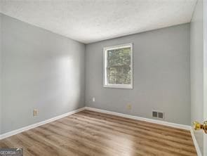 empty room with wood-type flooring