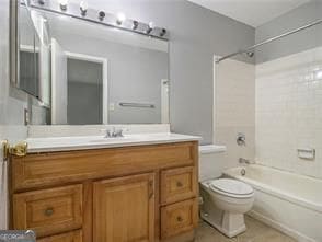 full bathroom featuring vanity, toilet, and tiled shower / bath combo