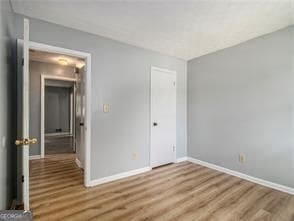 unfurnished bedroom with wood-type flooring