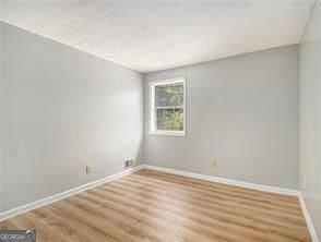 unfurnished room featuring hardwood / wood-style flooring