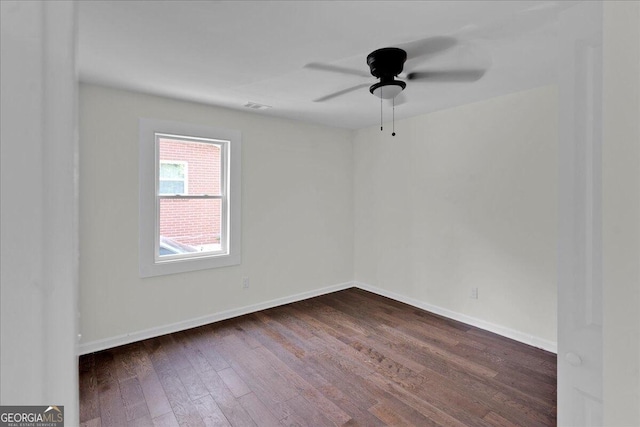 unfurnished room featuring ceiling fan and dark hardwood / wood-style flooring