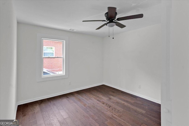 unfurnished room with ceiling fan and dark wood-type flooring