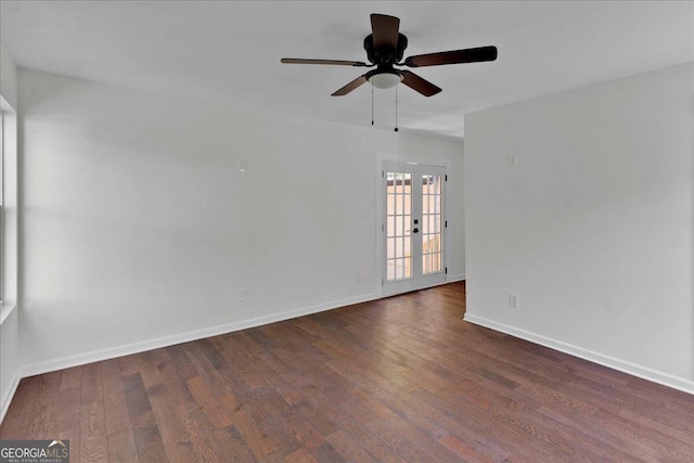 unfurnished room featuring dark hardwood / wood-style floors, ceiling fan, and french doors