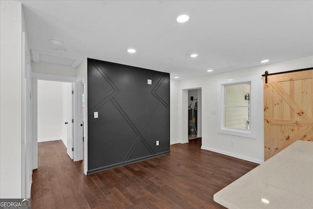 interior space featuring dark hardwood / wood-style floors and a barn door