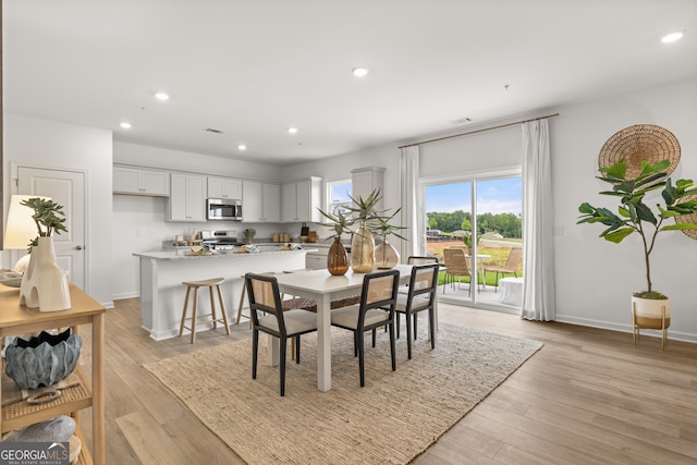 dining space with light wood-type flooring