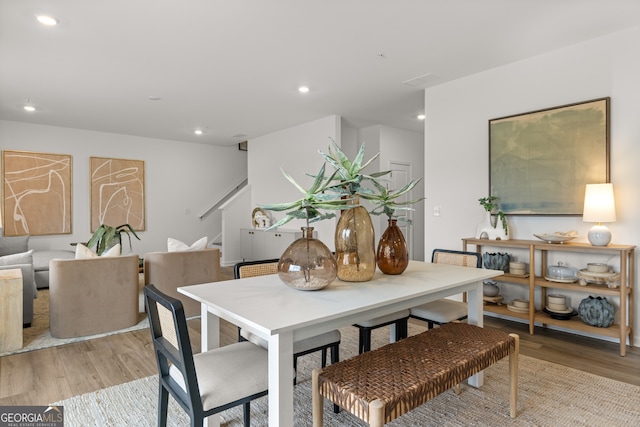 dining space with light hardwood / wood-style floors