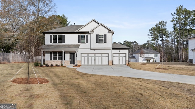 view of property featuring a garage and a front lawn