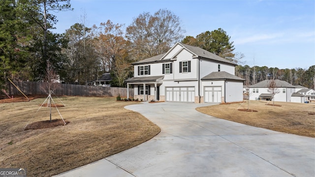 view of property featuring a garage and a front yard