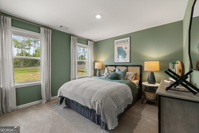 bedroom featuring carpet floors and multiple windows