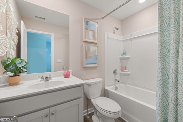 full bathroom with vanity, shower / bath combo, and toilet