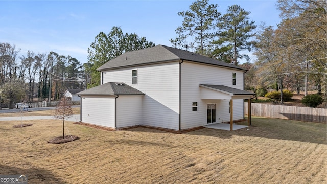 back of property featuring a yard and a patio area