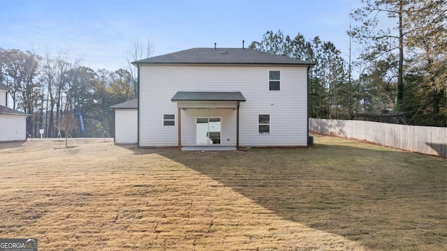 rear view of house with a patio area and a yard