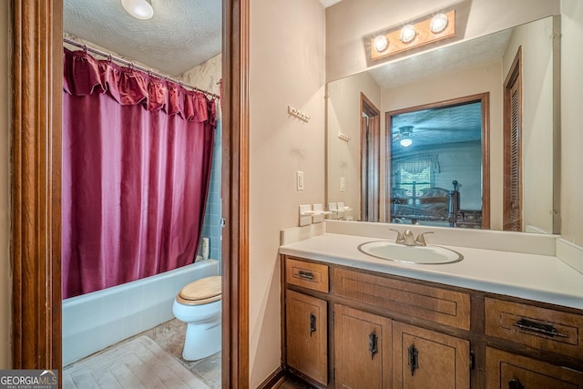 full bathroom with vanity, shower / bath combination with curtain, a textured ceiling, and toilet