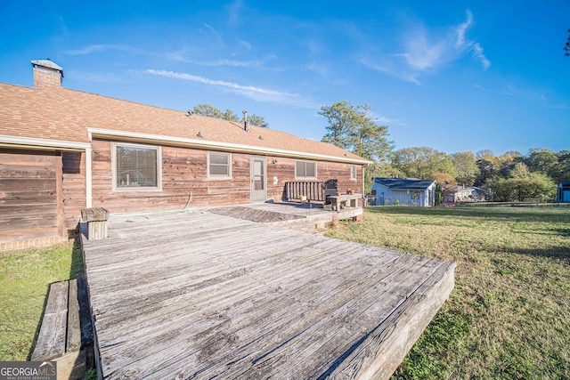 wooden deck with a lawn