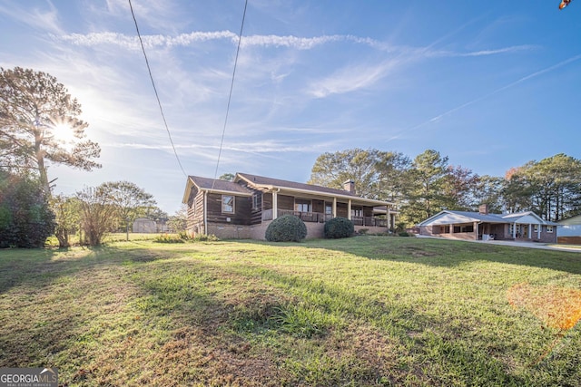 view of front of property with covered porch and a front lawn