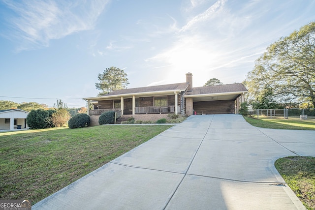 ranch-style house with a front yard, a porch, and a carport