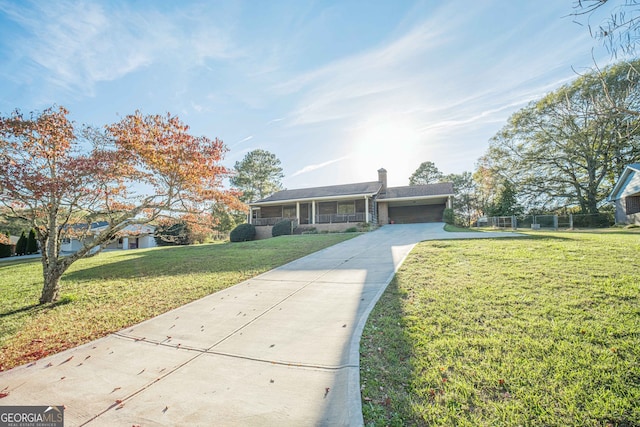 view of front of property featuring a front yard and a garage