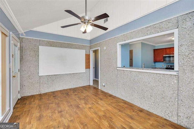 unfurnished room featuring wood-type flooring, high vaulted ceiling, ceiling fan, and ornamental molding