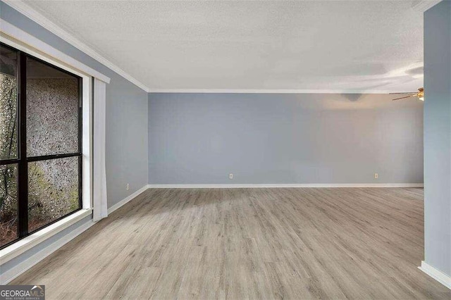 unfurnished room with crown molding, ceiling fan, light hardwood / wood-style floors, and a textured ceiling