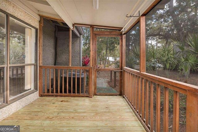 unfurnished sunroom with lofted ceiling