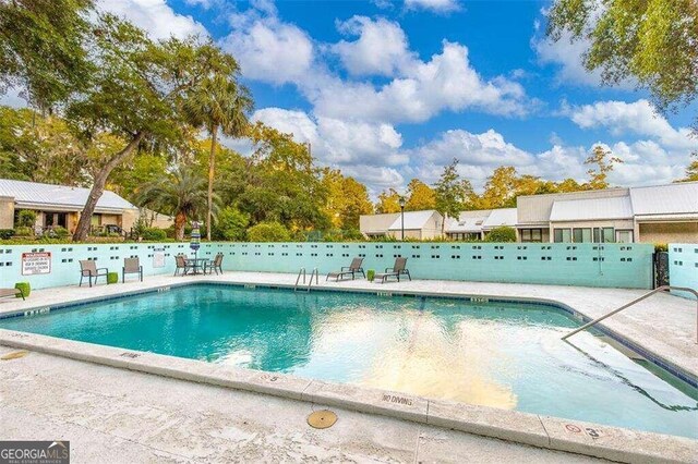 view of swimming pool featuring a patio area