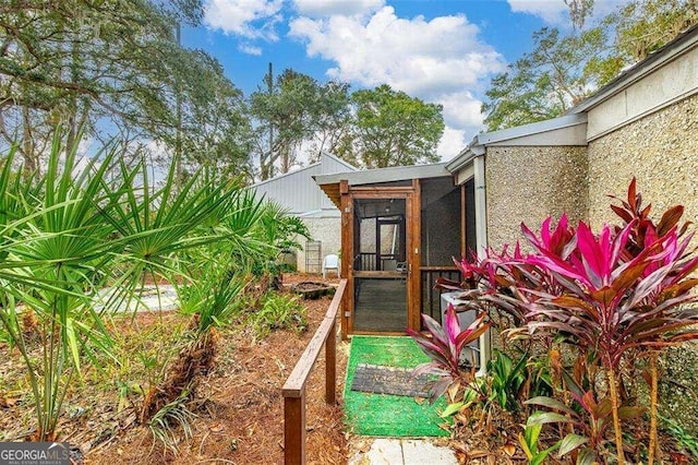 view of yard featuring a sunroom