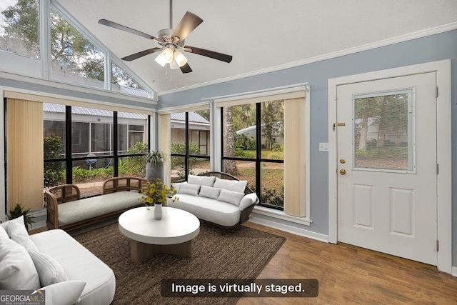 sunroom / solarium featuring ceiling fan and vaulted ceiling