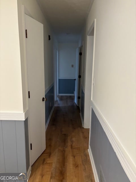 corridor with dark wood-type flooring