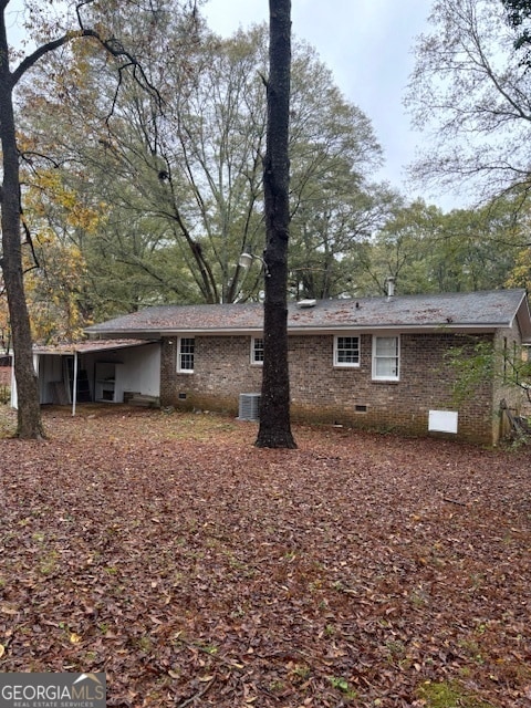 rear view of house with central AC