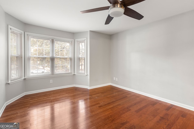 unfurnished room with ceiling fan, hardwood / wood-style floors, and a healthy amount of sunlight