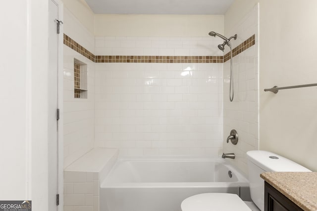 full bathroom with vanity, toilet, and tiled shower / bath