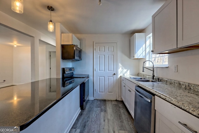 kitchen featuring white cabinets, appliances with stainless steel finishes, dark hardwood / wood-style floors, and dark stone countertops