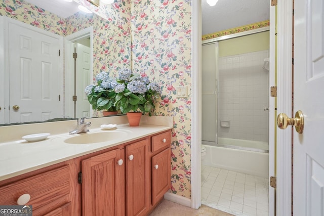 bathroom featuring vanity, tile patterned flooring, shower / bath combination with glass door, and a textured ceiling