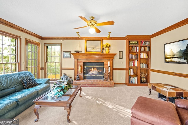 carpeted living room featuring crown molding, ceiling fan, a fireplace, and a textured ceiling