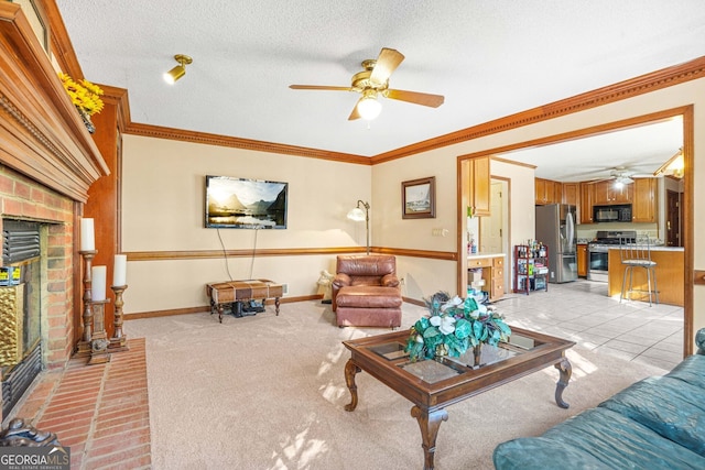 living room featuring a fireplace, ceiling fan, crown molding, light carpet, and a textured ceiling