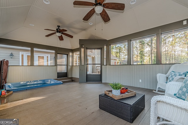 sunroom featuring ceiling fan and lofted ceiling