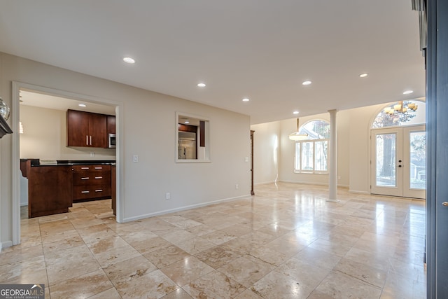 living room featuring french doors and decorative columns