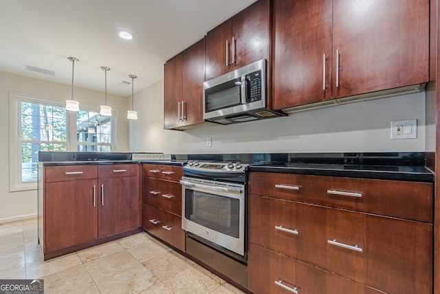 kitchen with kitchen peninsula, pendant lighting, and stainless steel appliances