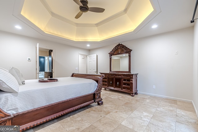 bedroom with a raised ceiling and ceiling fan