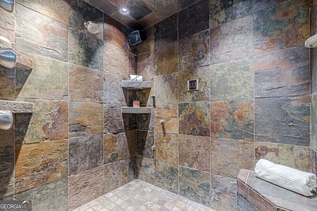 bathroom with a tile shower