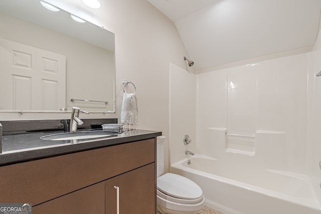 full bathroom featuring washtub / shower combination, toilet, lofted ceiling, and vanity