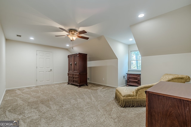 interior space with light colored carpet, vaulted ceiling, and ceiling fan