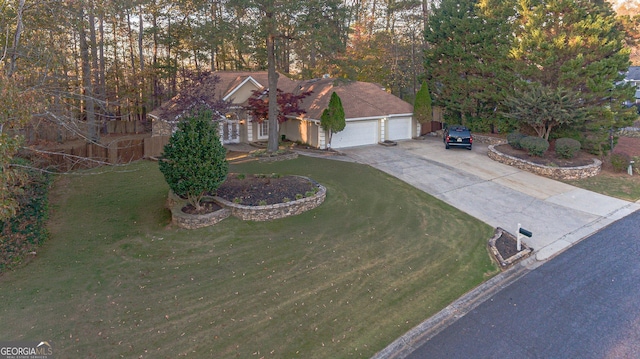 view of front of property featuring a front yard and a garage