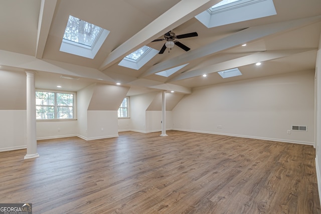 additional living space with vaulted ceiling with beams, ceiling fan, and light hardwood / wood-style flooring