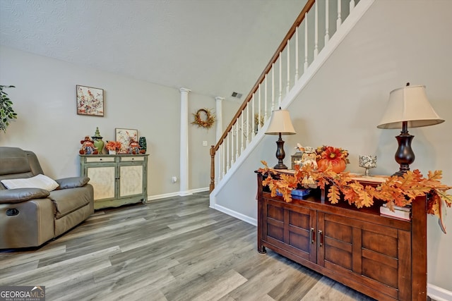 foyer featuring decorative columns and light hardwood / wood-style floors